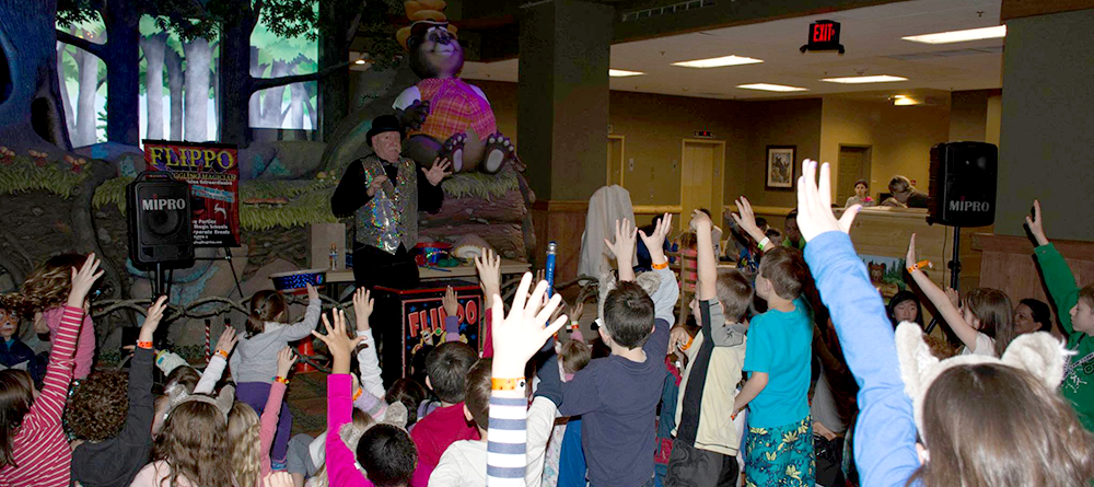 Flippo performing his act in front of a crowd of enthusiatic children