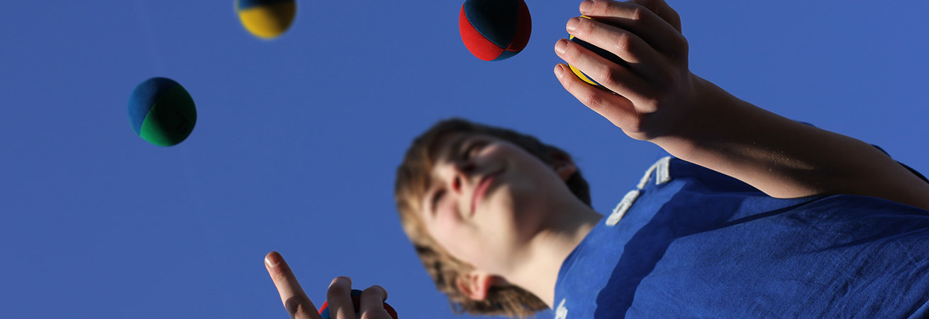 Young boy learning how to juggle