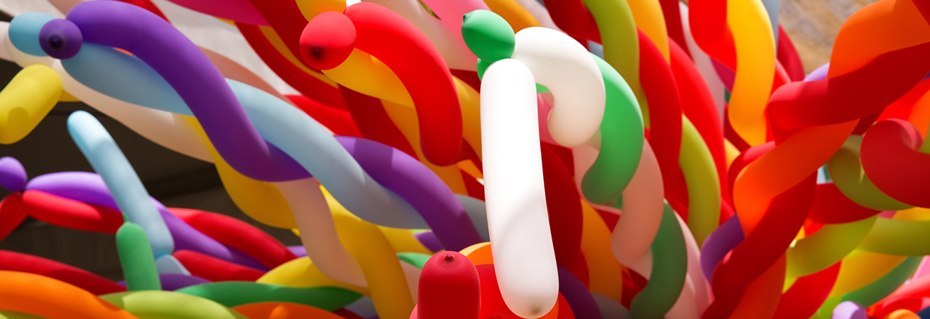 large group of colorful twisted balloons together
